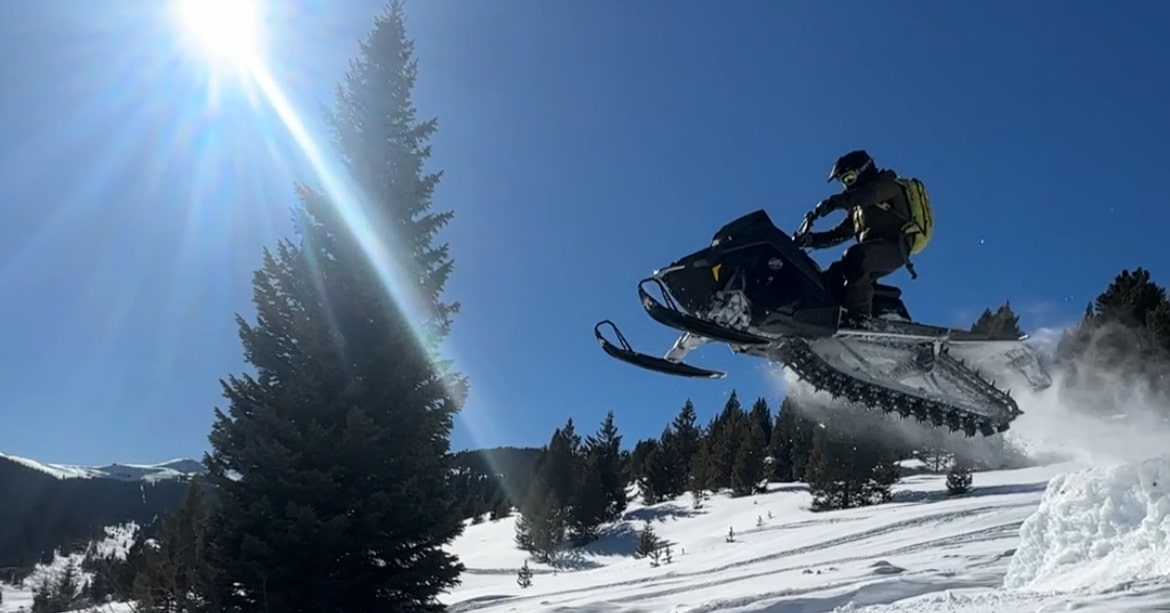 Snowmobiler catching air on a Colorado Mountain Rentals sled